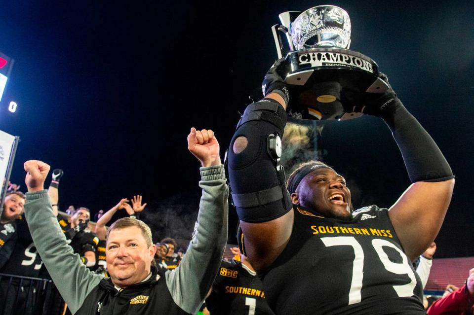 Southern Miss’ Tykeem Doss and Coach Will Hall celebrate after winning the Lending Tree Bowl at Hancock Whitney Stadium in Mobile, Alabama on Saturday, Dec. 17, 2022.