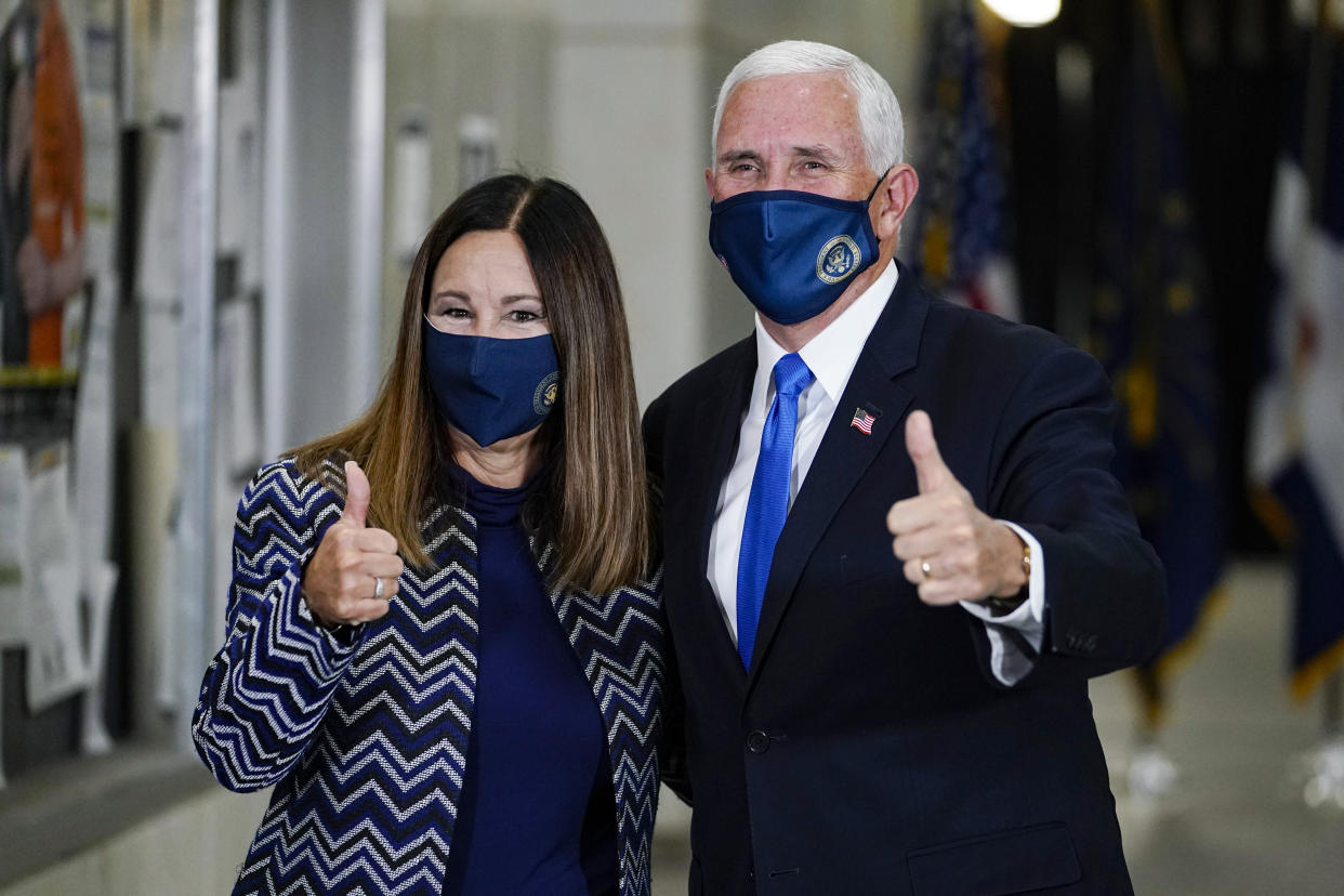 Vice President Mike Pence and his wife Karen give a thumbs up after casting their ballots during early voting in Indianapolis on Oct. 23, 2020. (Michael Conroy/AP)