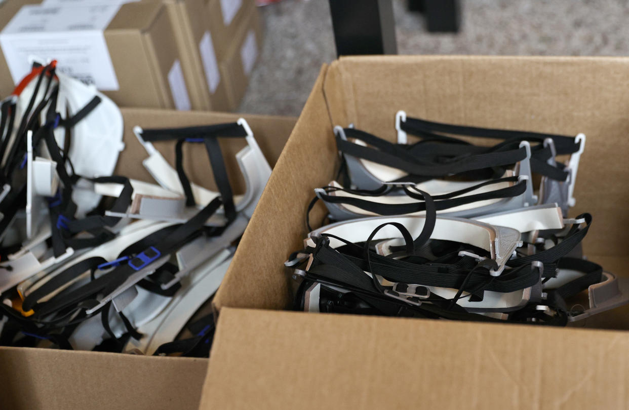 MAPLEWOOD, NJ - MARCH 29:  Assembled visors are seen in a box in the home of Jake Ezzo on March 29, 2020 in Maplewood, NJ. Residents of the South Orange, Maplewood and neighboring townships have banded together to make protective gear such as masks and face shields to aid area healthcare workers in the fight against the coronavirus. The SOMa Sewing Volunteers, a 365 member Facebook group, shares supplies and communicates through posts and messages. Crafters have turned their living and dining spaces into workspaces to accommodate large amounts of materials used to make this protective gear. Ezzo, the South Mountain Middle School Choir director, is new to 3D printing but learned quickly to help out the medical staffs of the Atlantic Health System of hospitals in New Jersey.  (Photo by Elsa/Getty Images)