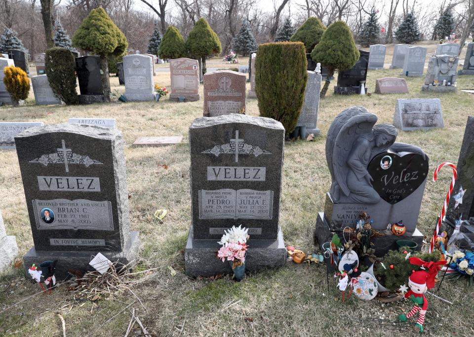 From left, the gravestones for Brian C. Velez, Pedro and Julia E. Velez and Vaniya Velez are pictured at Oakland cemetery in Yonkers, Feb. 7, 2023.