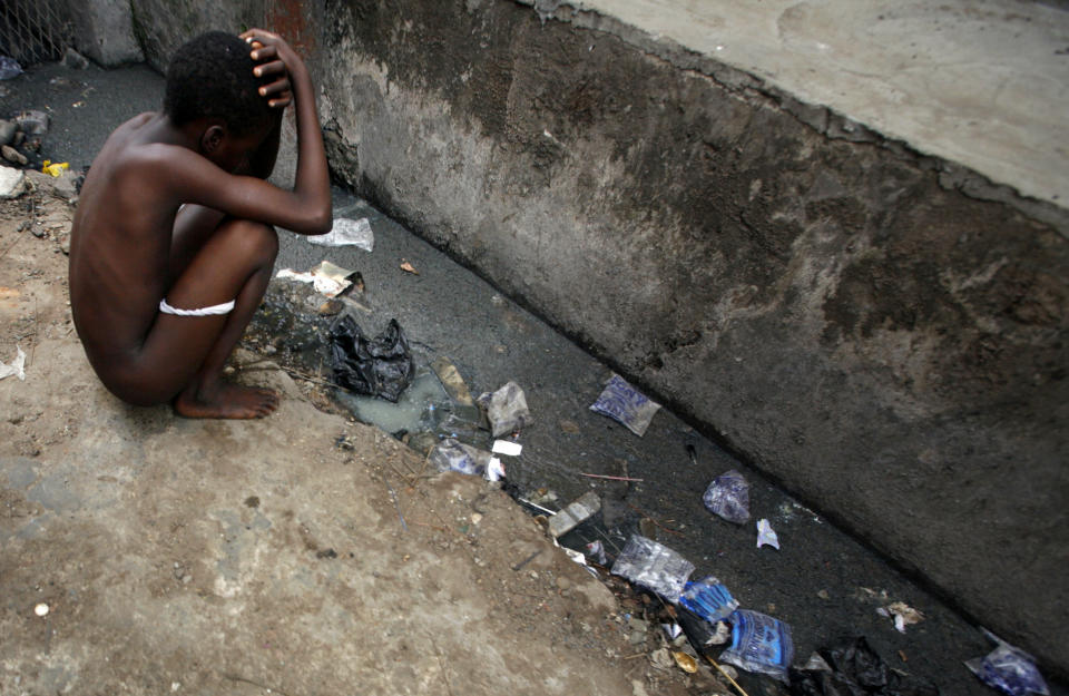 A child squats by an open sewer in central Lagos. A&nbsp;<a href="http://www.wateraid.org/~/.../Nigeriassanitationcrisis2016worldtoiletdaynigeriasupplement.pdf" target="_blank">2016 WaterAid report</a>&nbsp;finds almost&nbsp;70 percent of Nigeria's urban population does not have access to safe, private toilets and 1 in 4 people practice open defecation. (Photo: Finbarr O'Reilly/Reuters)