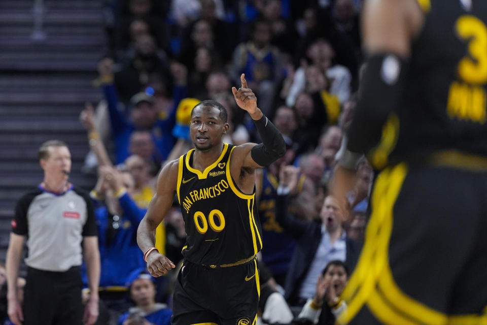 Golden State Warriors forward Jonathan Kuminga (00) gestures after scoring against the Memphis Grizzlies during the second half of an NBA basketball game Wednesday, March 20, 2024, in San Francisco. (AP Photo/Godofredo A. Vásquez)