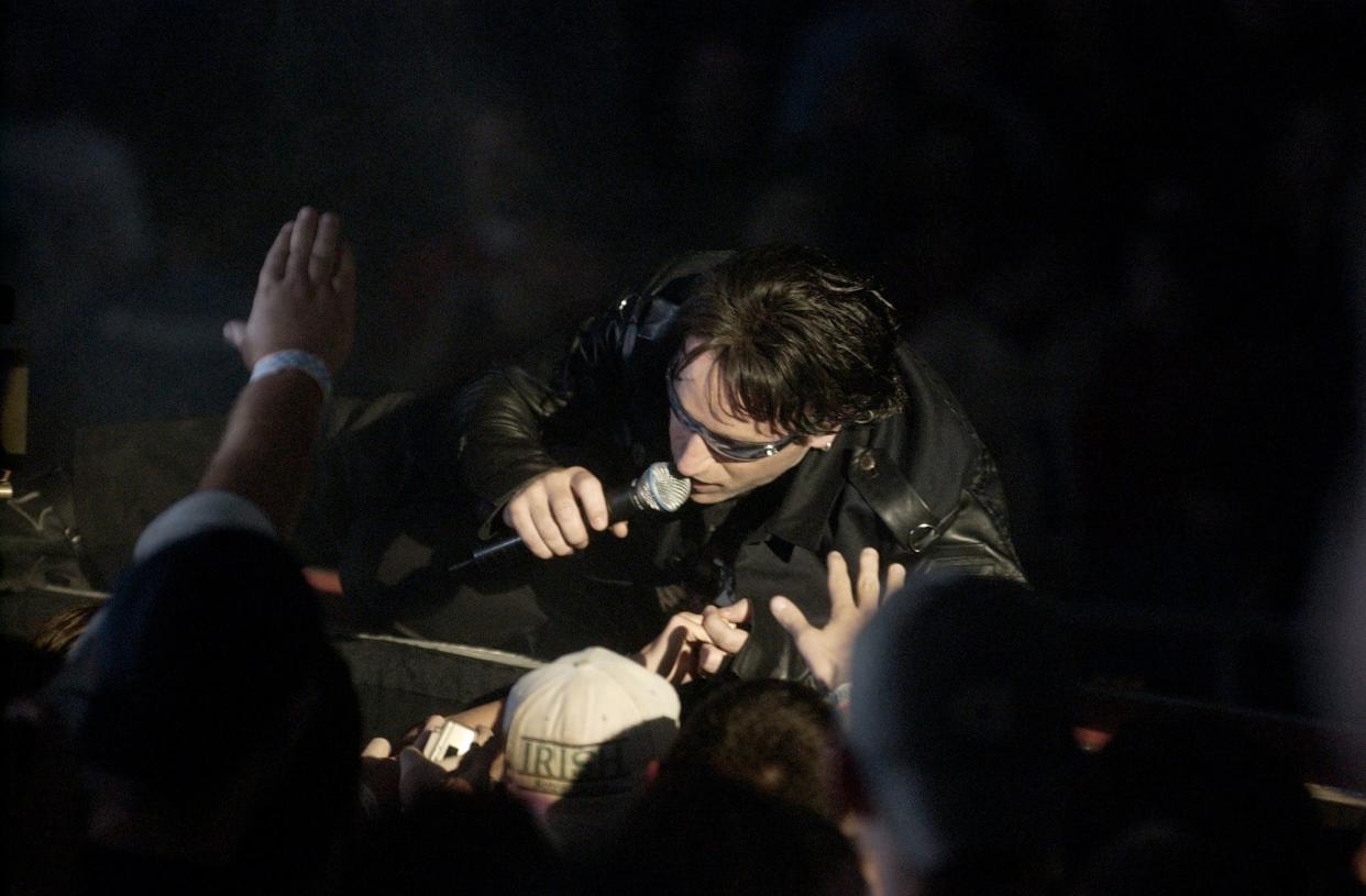 U2's Bono performs Oct. 10, 2001, to a packed arena at the University of Notre Dame's Joyce Athletic and Convocation Center.