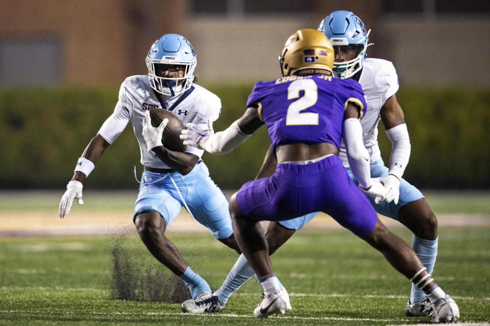 Old Dominion wide receiver Isiah Paige, left, makes a move to get around James Madison cornerback Chauncey Logan (2) during the first half of an NCAA college football game Saturday, Oct. 28, 2023, in Harrisonburg, Va. (AP Photo/Mike Caudill)