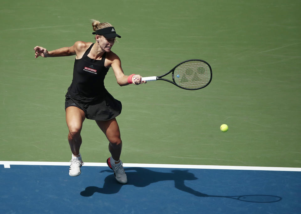 Angelique Kerber, of Germany, returns a shot to Dominika Cibulkova, of Slovakia, during the third round of the U.S. Open tennis tournament, Saturday, Sept. 1, 2018, in New York. (AP Photo/Andres Kudacki)