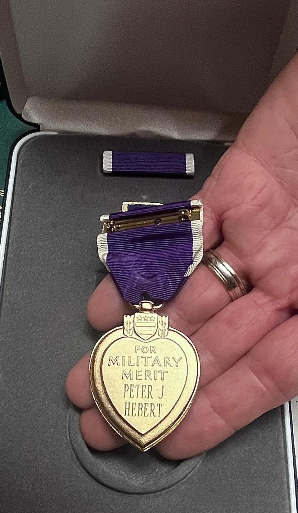 Vinnie Hebert of Dighton holds the Purple Heart that was recently awarded to his grandfather Peter J. Hebert of Taunton, who was wounded in France in 1918 during World War I.