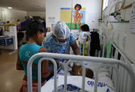 A Yanomami baby is assisted by a nurse at the Santo Antonio Children's Hospital, in Boa Vista, Roraima state, Brazil, Thursday, Jan 26, 2023. Brazil's government declared a public health emergency for the Yanomami people in the Amazon, who are suffering from malnutrition and diseases such as malaria. (AP Photo/Edmar Barros)