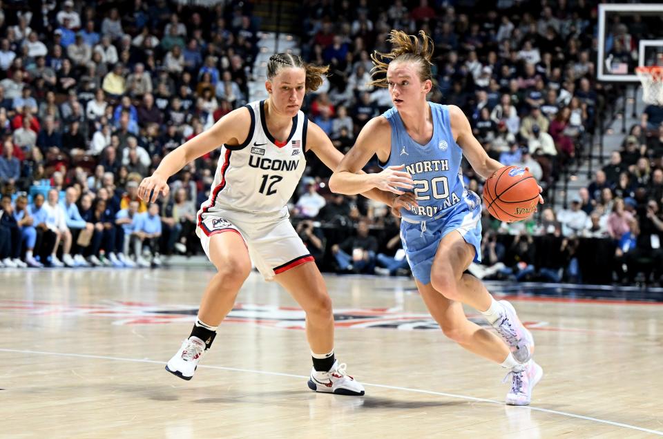 UNCASVILLE, CONNECTICUT - DECEMBER 10: Lexi Donarski #20 of the North Carolina Tar Heels handles the ball in the first quarter against Ashlynn Shade #12 of the UConn Huskies at Mohegan Sun Arena on December 10, 2023 in Uncasville, Connecticut. (Photo by Greg Fiume/Getty Images)