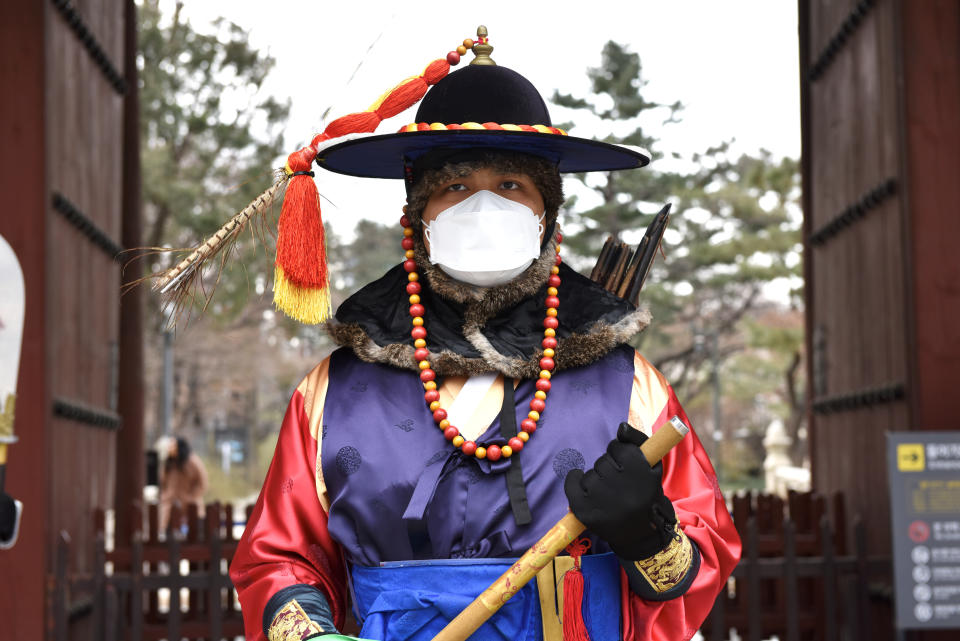 SEOUL, SOUTH KOREA - FEBRUARY 7, 2020: A royal guard in a medical mask by the Deoksugung Palace in central Seoul. The Chinese authorities registered an outbreak of the 2019-nCoV coronavirus in Wuhan in December 2019; as of February 7, 2020, the number of people infected with the new strain of coronavirus has risen over 30,000, the death toll is over 600. Stanislav Varivoda/TASS (Photo by Stanislav Varivoda\TASS via Getty Images)