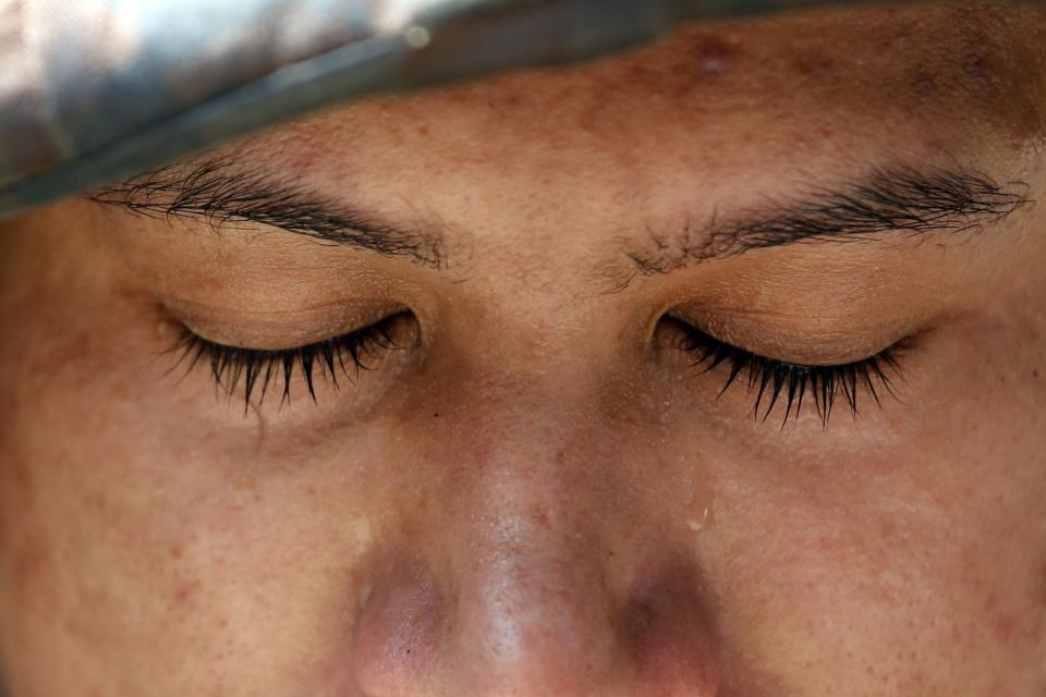 A teardrop rolls down the face of a soldier, whose unit was deployed to control protesters against military rule, at Bangkok's shopping district May 25, 2014. Thailand's military tightened its grip on power on Sunday as it moved to douse smouldering protests fuelled by social media and to rally commercial agencies and business to revitalise a battered economy. REUTERS/Damir Sagolj (THAILAND - Tags: SOCIETY CIVIL UNREST POLITICS MILITARY TPX IMAGES OF THE DAY)