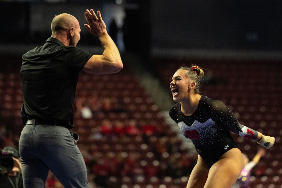 Utah Utes Makenna Smith celebrates with her coach after her vault during the Sprouts Farmers Market Collegiate Quads at Maverik Center in West Valley on Saturday, Jan. 13, 2024. #1 Oklahoma, #2 Utah, #5 LSU, and #12 UCLA competed in the meet. | Megan Nielsen, Deseret News