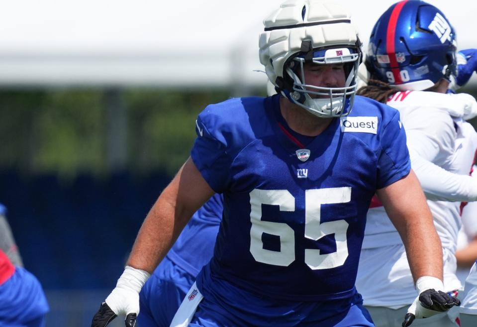 Jul 26, 2024; East Rutherford, NJ, USA; New York Giants offensive guard Austin Schlottmann (65) does a drill during training camp at Quest Diagnostics Training Center. Mandatory Credit: Lucas Boland-USA TODAY Sports