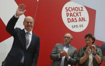 German Social Democratic Party, SPD, party leaders Saskia Esken, right, and Norbert Walter-Borjans, center, applaud to the party's candidate for chancellery Olaf Scholz as he arrives at the meeting of the SPD Federal Executive Committee in Berlin, Germany, Monday, Sept. 27, 2021. Following Sunday's election leaders of the German parties were meeting Monday to digest a result that saw Merkel’s Union bloc slump to its worst-ever result in a national election and appeared to put the keys to power in the hands of two opposition parties. Both Social Democrat Olaf Scholz and Armin Laschet, the candidate of Merkel's party, laid a claim to leading the next government. (Wolfgang Kumm/dpa via AP)