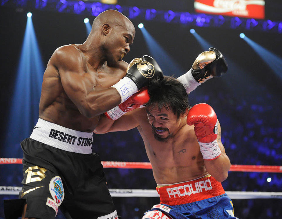 Manny Pacquiao, right, from the Philippines, and Timothy Bradley, from Palm Springs, Calif., trade blows in the first round of their WBO welterweight title fight Saturday, June 9, 2012, in Las Vegas.