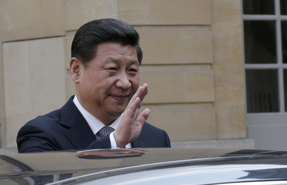 Chinese President Xi Jinping, waves to reporters as he leaves after a meeting with France's Prime Minister Jean Marc Ayrault, in Paris, Thursday March 27, 2014. Deal-making and commemorations of a half-century of French diplomatic ties with Communist China were the order of business during Xi's three-day visit, part of his European tour. (AP Photo/Christophe Ena, Pool)