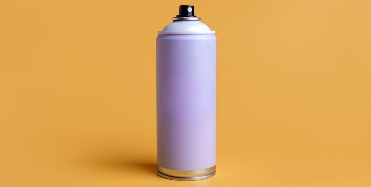 aerosol spray can on yellow background