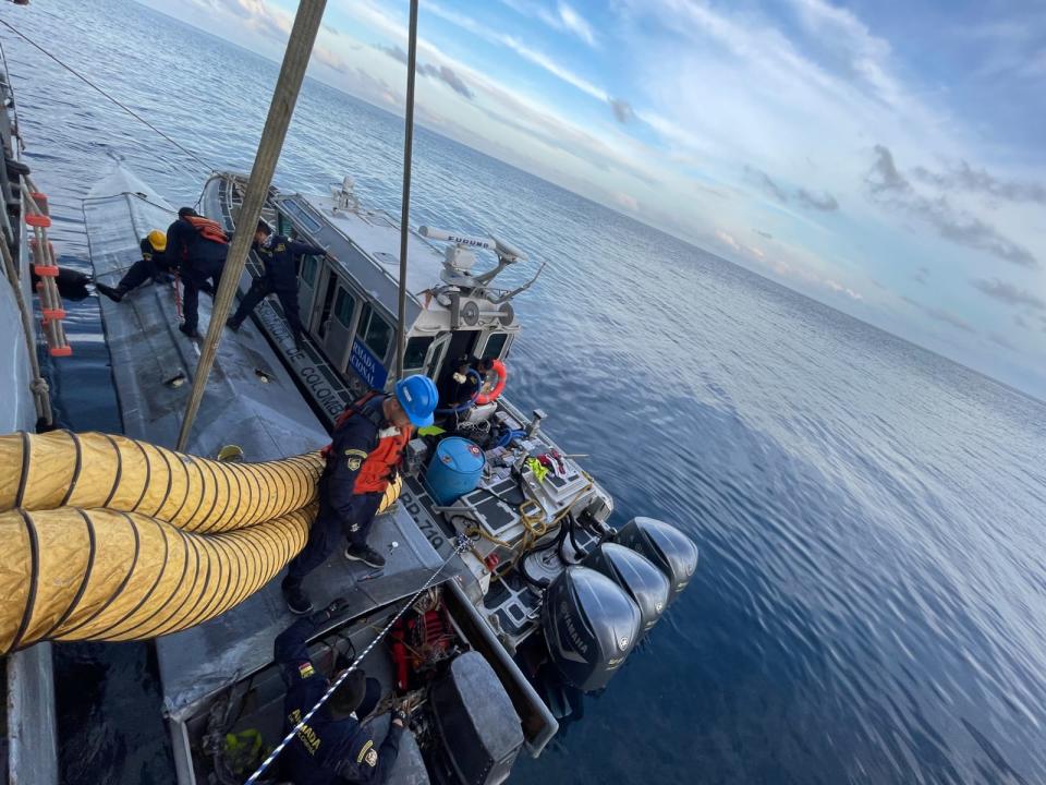 Colombia navy servicemen investigate aboard the submarine.