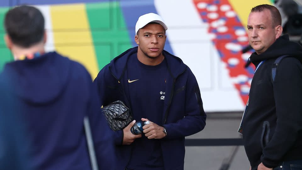 French soccer star Kylian Mbappé, center, leaves the stadium after a training session in Hamburg, Germany, on July 4, 2024. - Franck Fife/AFP/Getty Images