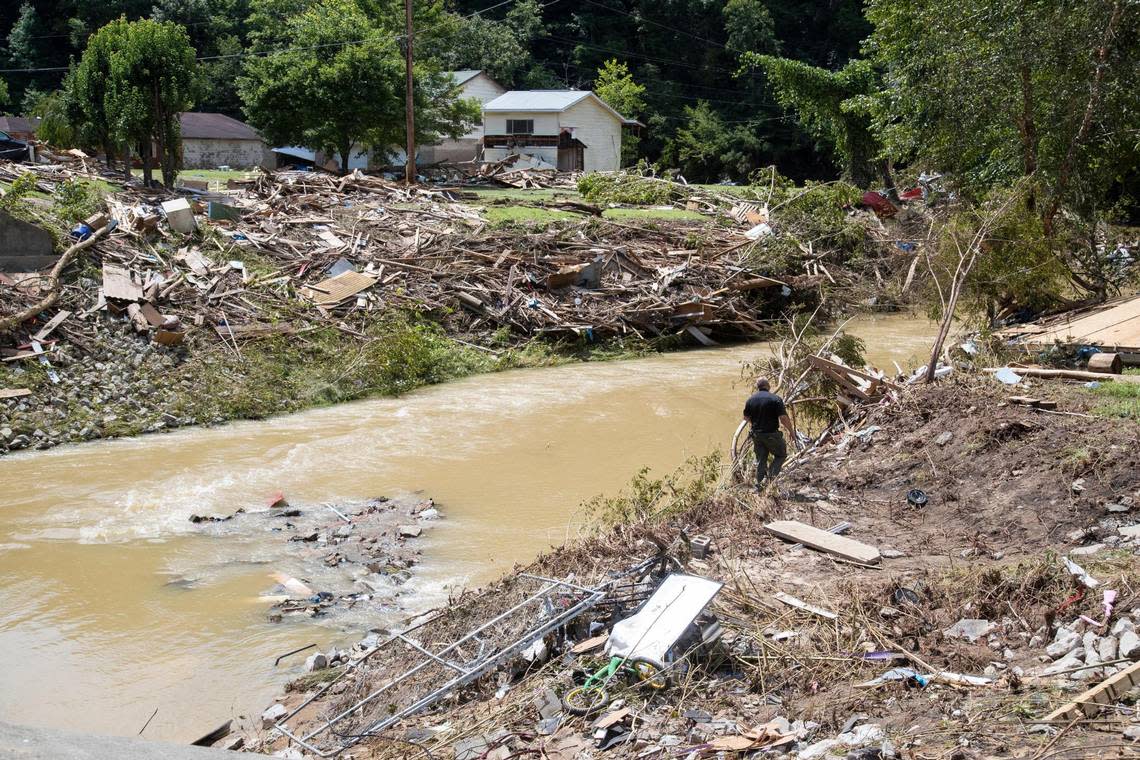 Search and Rescue units look around Troublesome Creek for, at least, two people who are still missing after flooding swept through the area Floodwaters damage things in places, Ky., Saturday, July 30, 2022.