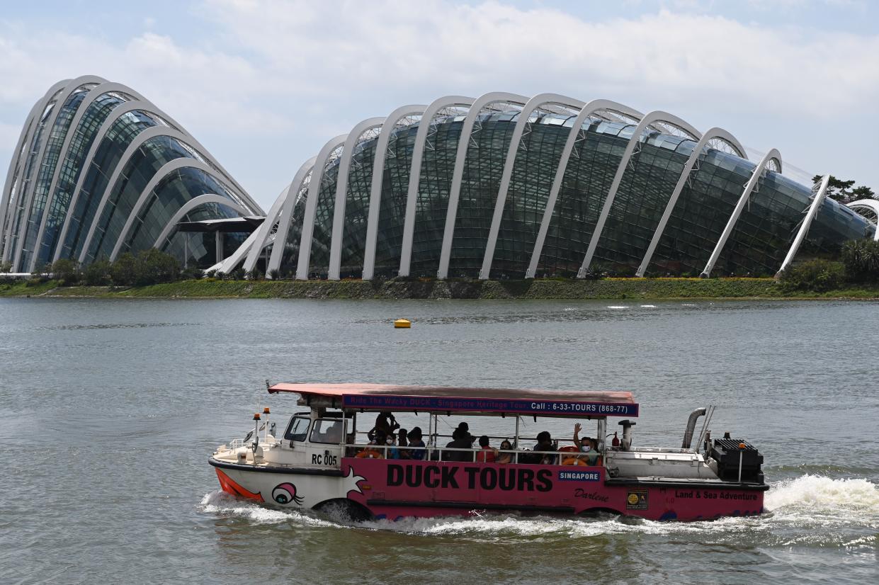 Tourists ride on an amphibious 
