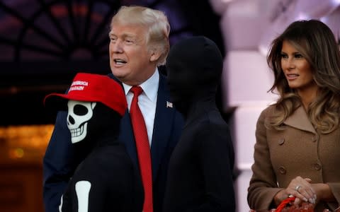 U.S. President Donald Trump and First Lady Melania Trump give out Halloween treats to children in Washington - Credit: Reuters