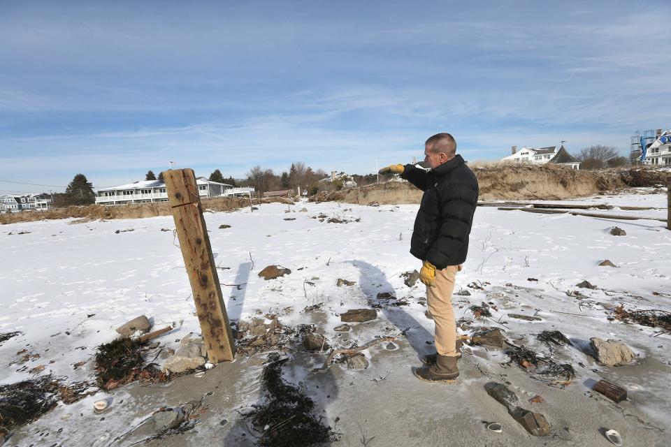 Ken Mason, the innkeeper of the Seaside Inn in Kennebunkport, shows how high the ocean water reached when it demolished the seawall and the dunes in front of his property. The last storm caused severe erosion in the area.