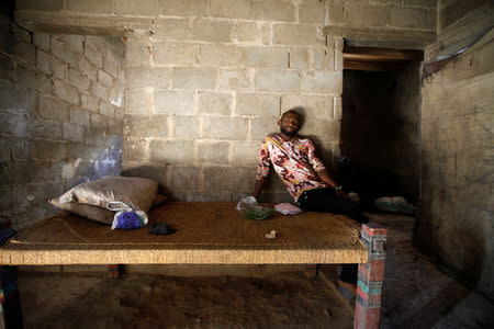 A man displaced from the Red Sea port city of Hodeidah sits on a bed in a shelter in Sanaa, Yemen November 1, 2018. Picture taken November 1, 2018. REUTERS/Mohamed al-Sayaghi