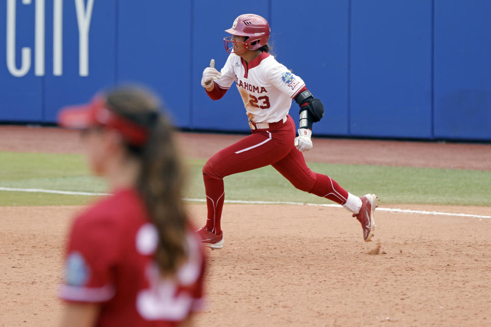 Oklahoma's Tiare Jennings (23) runs to second base after hitting a two-RBI double against Stanford during the ninth inning of an NCAA softball Women's College World Series game Monday, June 5, 2023, in Oklahoma City. (AP Photo/Nate Billings)