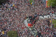 Fans cheer during the Toronto Raptors NBA basketball championship victory parade in Toronto, Monday, June 17, 2019. (Andrew Lahodynskyj/The Canadian Press via AP)