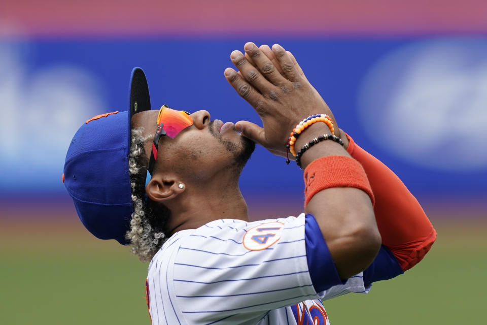 New York Mets shortstop Francisco Lindor reacts after the national anthem was played before a baseball game against the Miami Marlins, Saturday, April 10, 2021, in New York. (AP Photo/John Minchillo)