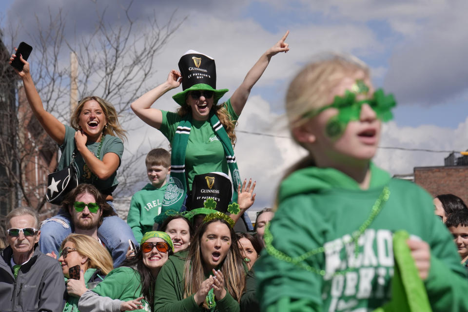 Spectators watch the St. Patrick's Day parade, Sunday, March 17, 2024, in Boston's South Boston neighborhood. (AP Photo/Steven Senne)