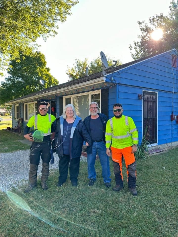 Osmar Vargas, left, Sharon Johnson, Mark Johnson and Rodolfo Loaeza, who comprise Loaeza & Vargas Tree Service, took down a tree for a local family in need at no cost.