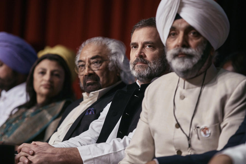 Indian politician Rahul Gandhi, second right, takes a seat as he arrives at the Javits Center, Sunday, June 4, 2023, in New York. (AP Photo/Andres Kudacki)