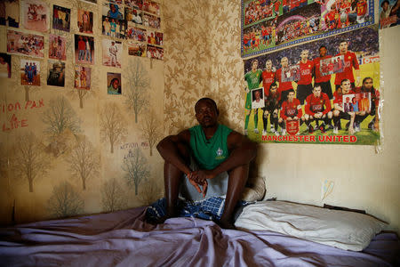 Bubacar Samba, a Gambian migrant who voluntarily returned from Libya, sits on a bed at his home in Brikama, Gambia April 5, 2017. REUTERS/Luc Gnago