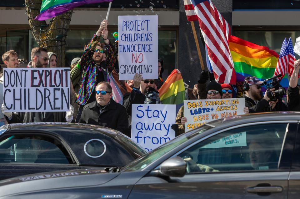 Protesters picket with signs outside Sidetrack Bookshop during a Drag Queen Story Time in Royal Oak on Saturday, March 11, 2023.