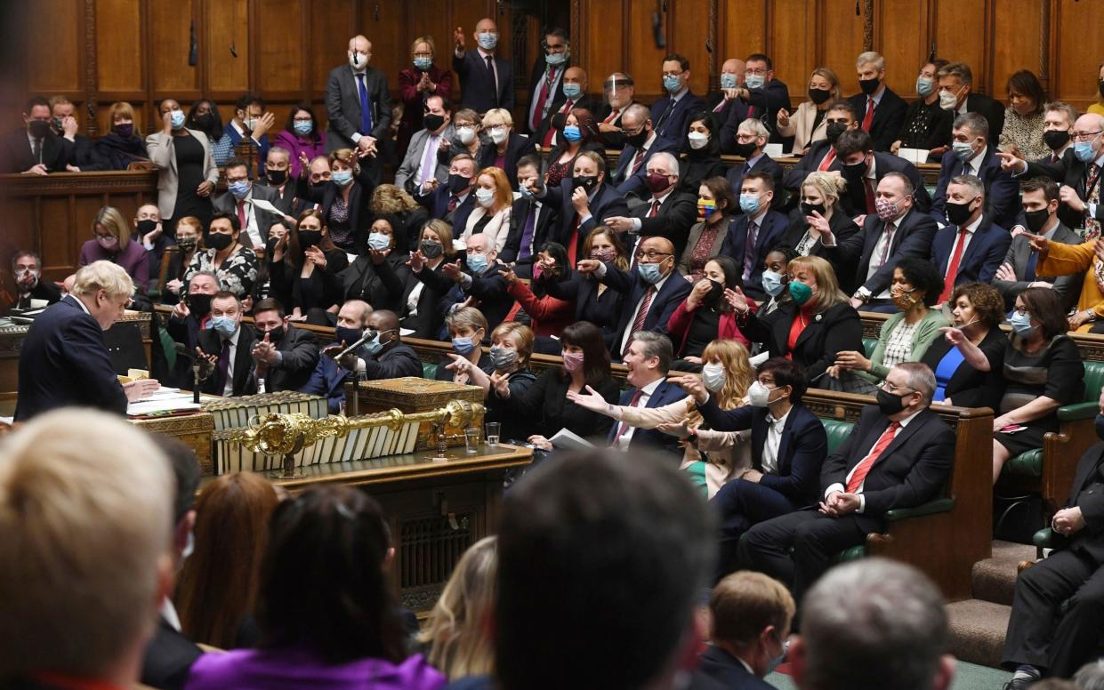 Boris Johnson speaks as members of the opposition party gesture, during Prime Minister's Questions in the House of Commons - Jessica Taylor/UK Parliament