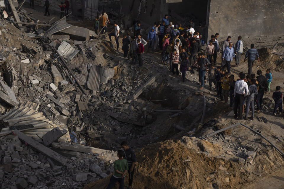 Palestinians inspect the rubble of a house after it was struck by an Israeli airstrike in Beit Lahia, northern Gaza Strip, Friday, May 12, 2023. On the fourth day of fighting between Israel and Islamic Jihad, the second-largest militant group in Gaza.(AP Photo/Fatima Shbair)