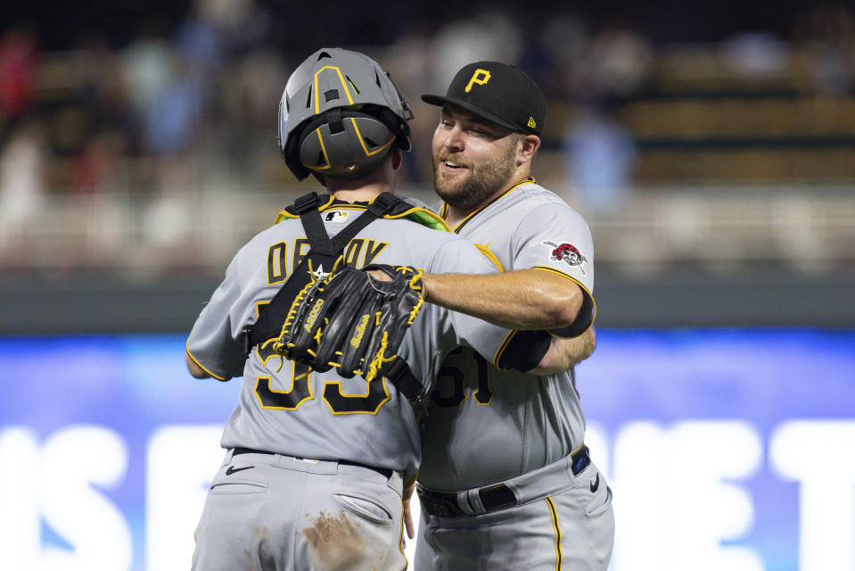 Pittsburgh Pirates relief pitcher David Bednar, right, celebrates with catcher Jason Delay, left, after defeating the Minnesota Twins in a baseball game Saturday, Aug. 19, 2023, in Minneapolis. (AP Photo/Bailey Hillesheim)