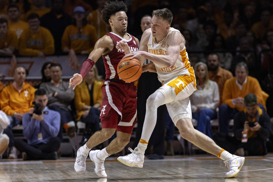 Tennessee guard Dalton Knecht (3) drives as he's defended by Alabama guard Mark Sears (1) during the second half of an NCAA college basketball game Saturday, Jan. 20, 2024, in Knoxville, Tenn. (AP Photo/Wade Payne)