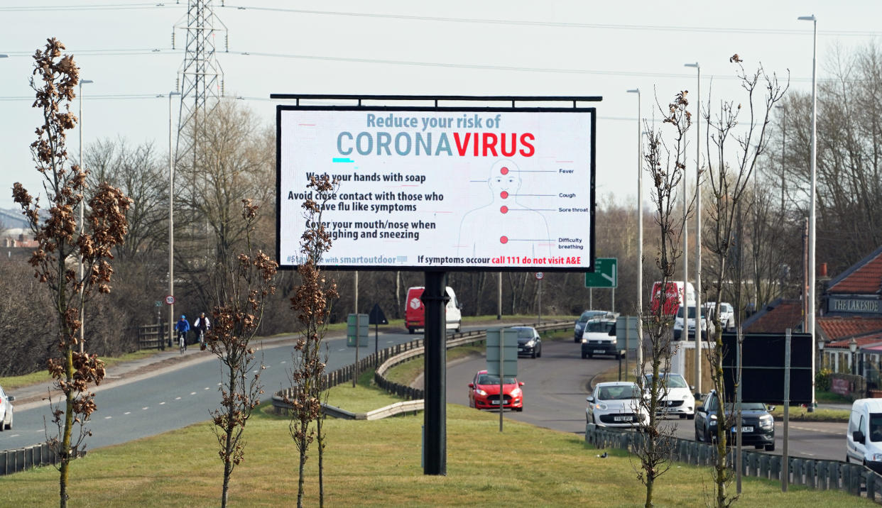 A sign on the A194 dual carriageway in South Shields warns motorists of the symptoms of coronavirus and the measures that can be taken to avoid it. (Photo by Owen Humphreys/PA Images via Getty Images)