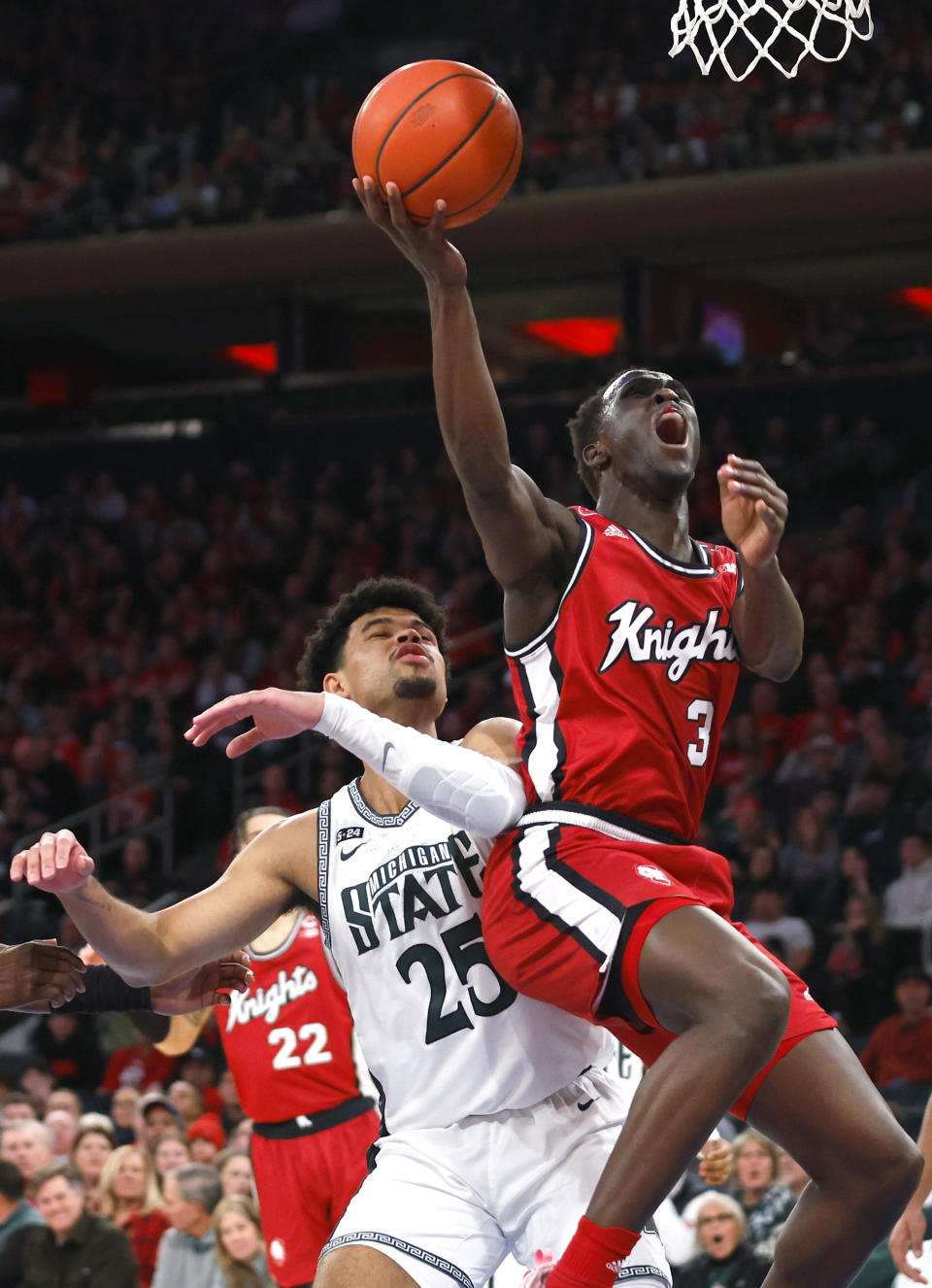Rutgers forward Mawot Mag (3) drives to the basket against Michigan State forward Malik Hall (25) during the first half of an NCAA college basketball game in New York, Saturday, Feb. 4, 2023. (AP Photo/Noah K. Murray)