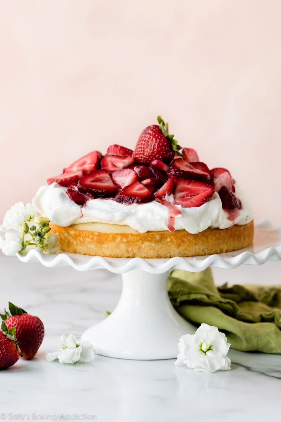 spring cake recipes one layer strawberry shortcake on white cake stand with flowers