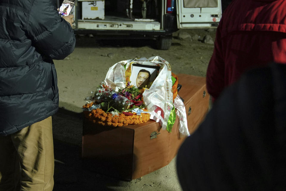 A portrait is displayed on the coffin of a victim of Sunday's plane crash in Pokhara, Nepal, Monday, Jan 16, 2023. At least 69 of the 72 people aboard were killed, and officials believe the three missing are also dead. Rescuers combed through the debris, scattered down a 300-meter-deep (984-foot-deep) gorge, for them. (AP Photo/Yunish Gurung)