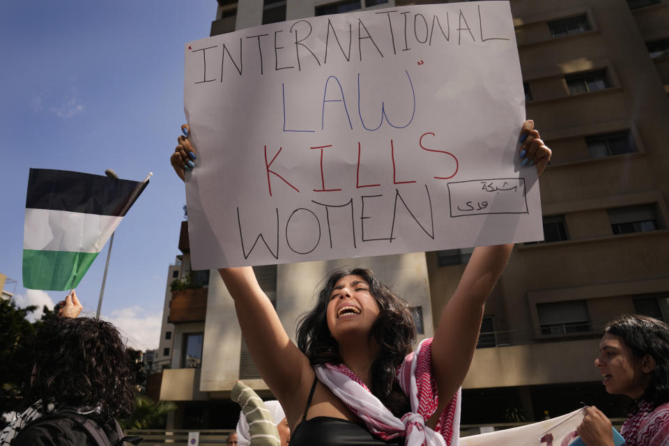 A Lebanese woman holds up a placard as she shouts slogans during a protest in support of Palestinian women on the International Women's Day outside the office of a U.N. organisation, in Beirut, Lebanon, Friday, March 8, 2024. The U.N. agency for Palestinian refugees says about 9,000 women have been killed in the Gaza Strip since the Israel-Hamas war began five months ago. (AP Photo/Hussein Malla)