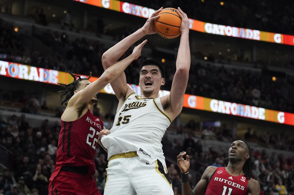 Purdue's Zach Edey (15) grabs a rebound against Rutgers' Caleb McConnell (22) during the second half of an NCAA college basketball game at the Big Ten men's tournament, Friday, March 10, 2023, in Chicago. (AP Photo/Erin Hooley)