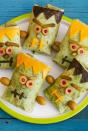 <p>Make app-sized sandwiches come to life with sliced Cheddar, olives and cornichon pickles that form a monstrous face!</p><p>Get the <strong><a href="https://www.womansday.com/food-recipes/a33564111/monster-wraps-recipe/" rel="nofollow noopener" target="_blank" data-ylk="slk:Monster Wraps recipe;elm:context_link;itc:0;sec:content-canvas" class="link ">Monster Wraps recipe</a> </strong>from Woman's Day. </p><p><strong>RELATED: </strong><a href="https://www.goodhousekeeping.com/holidays/halloween-ideas/g565/halloween-party-ideas/" rel="nofollow noopener" target="_blank" data-ylk="slk:Scary-Good Halloween Party Ideas to Guarantee a Good Time;elm:context_link;itc:0;sec:content-canvas" class="link ">Scary-Good Halloween Party Ideas to Guarantee a Good Time</a></p>