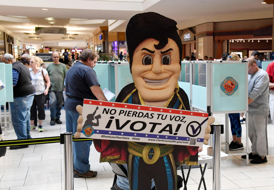 People vote behind an Elvis Presley-themed cardboard cutout on the first day of early voting at the Meadows Mall in Las Vegas on Oct. 20, 2018. (Photo: Ethan Miller/Getty Images)