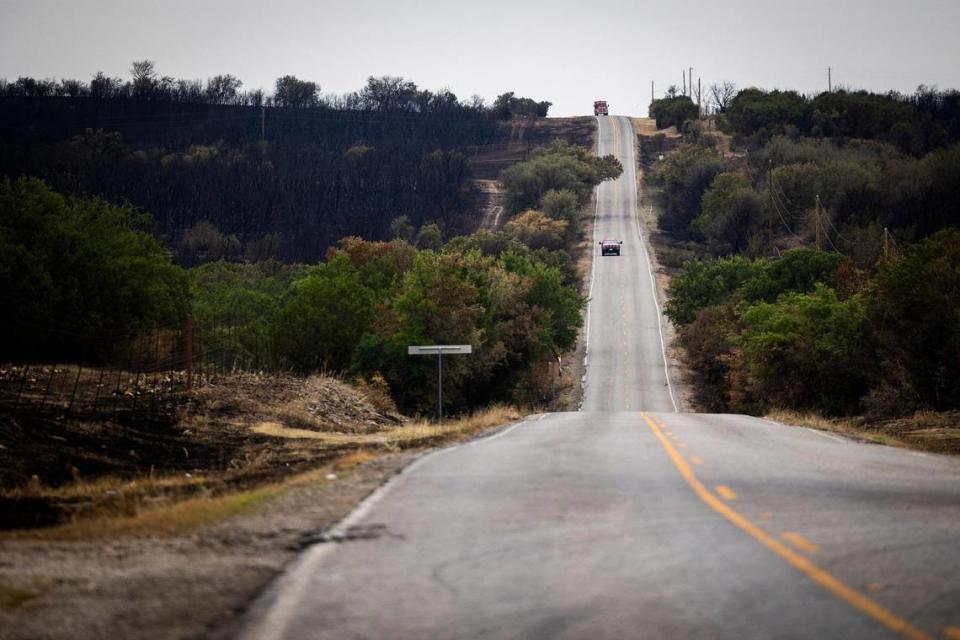 Fire crews drive down the hill as the Dempsey Fire ravaged almost 12,000 acres Monday, June 27, 2022 near Palo Pinto.