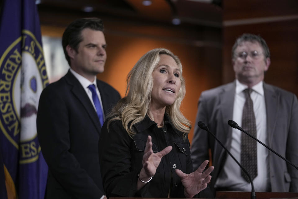 FILE - Rep. Marjorie Taylor Greene, R-Ga., joined by Rep. Matt Gaetz, R-Fla., left, and Rep. Thomas Massie, R-Ky., speaks during a news conference at the Capitol in Washington, Nov. 17, 2022. (AP Photo/J. Scott Applewhite, File)