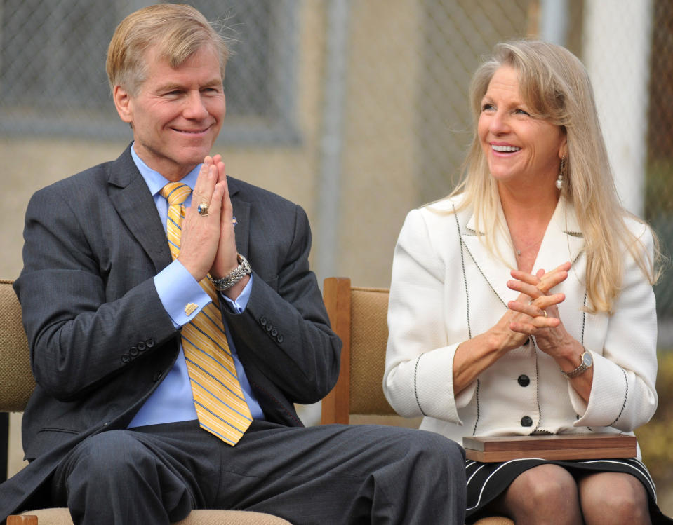 FILE - In this Oct. 22, 2013 file photo, then Virginia Gov. Bob McDonnell and First Lady Maureen McDonnell clasp their hands during an event at Saint Joseph School in Petersburg, Va. McDonnell and his wife were indicted Tuesday, Jan. 21, 2014, on corruption charges after a monthslong federal investigation into gifts the Republican received from a political donor. (AP Photo/The Progress-Index, Patrick Kane, File)